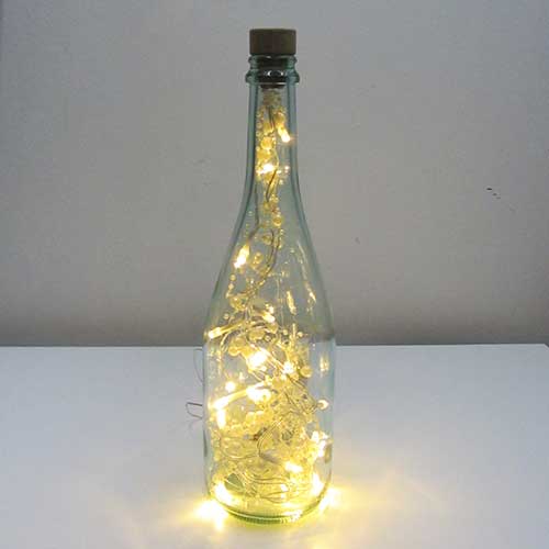 I was a bottle: Glas-Flaschen - Lampen und Leuchten, Laternen, Gläser, Led-Flaschenlampen: Flachen-Lampe, Weissglas, mit Perlen-Led Licht, goldgelb